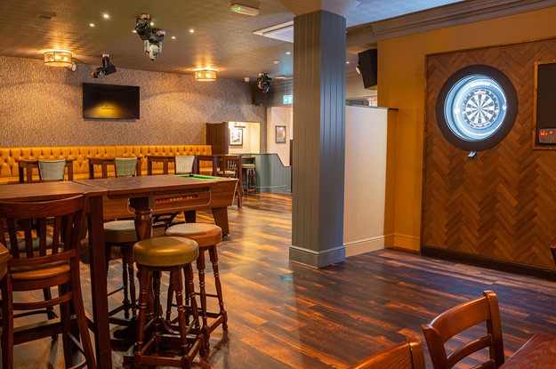 The Lowther pub seating with dart board