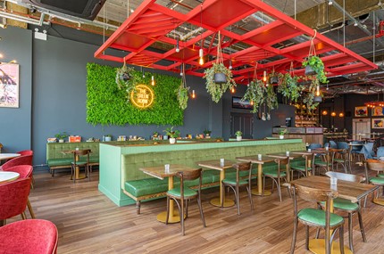 Restaurant dining area with bright seating and artwork