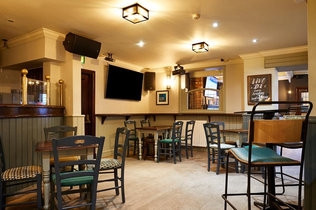 wood panelled pub with wood furniture 