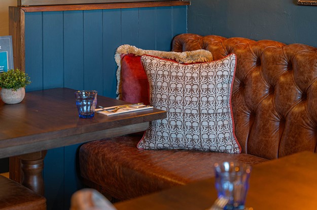 fixed seating at the crown with cushions 