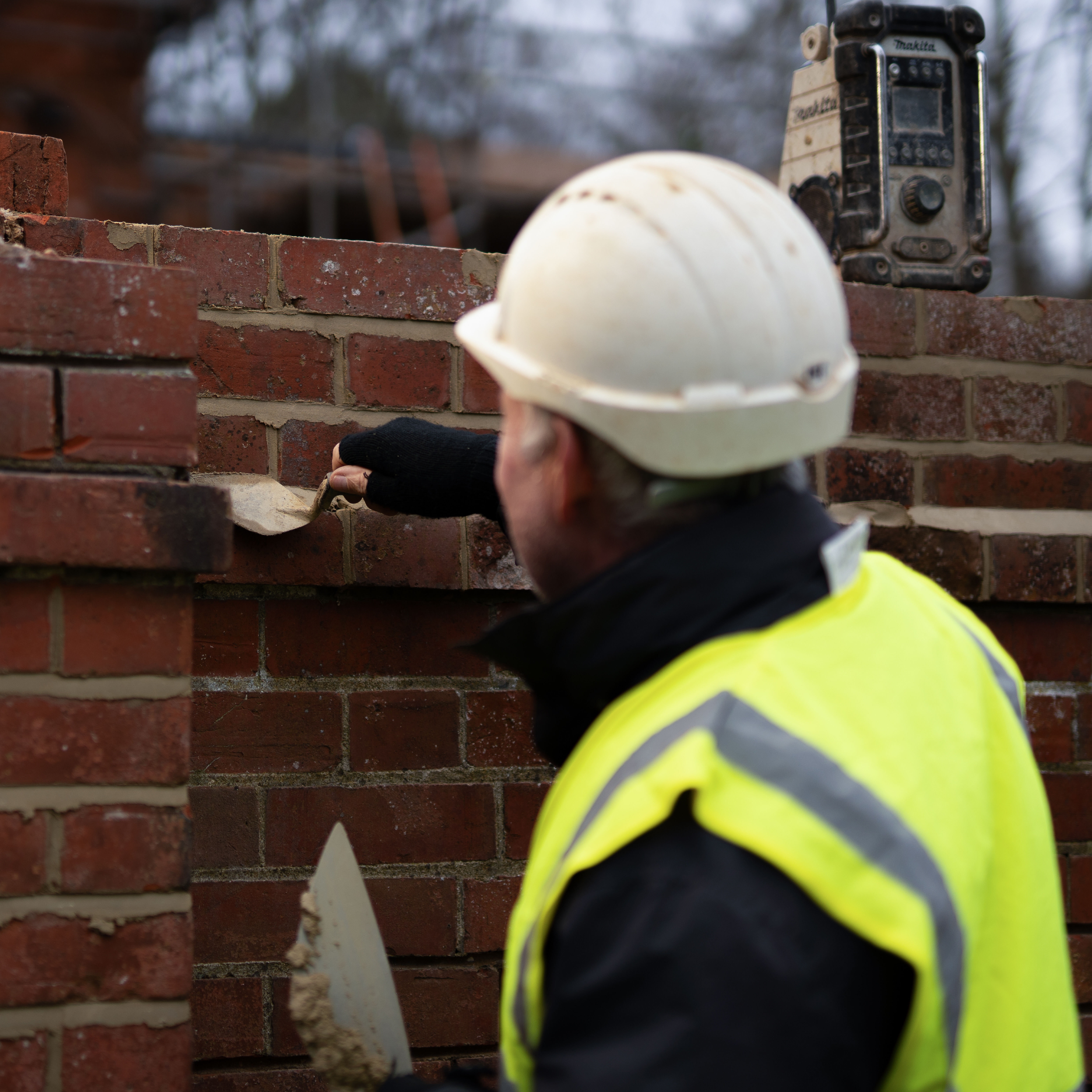 Builder action shot of bricklaying