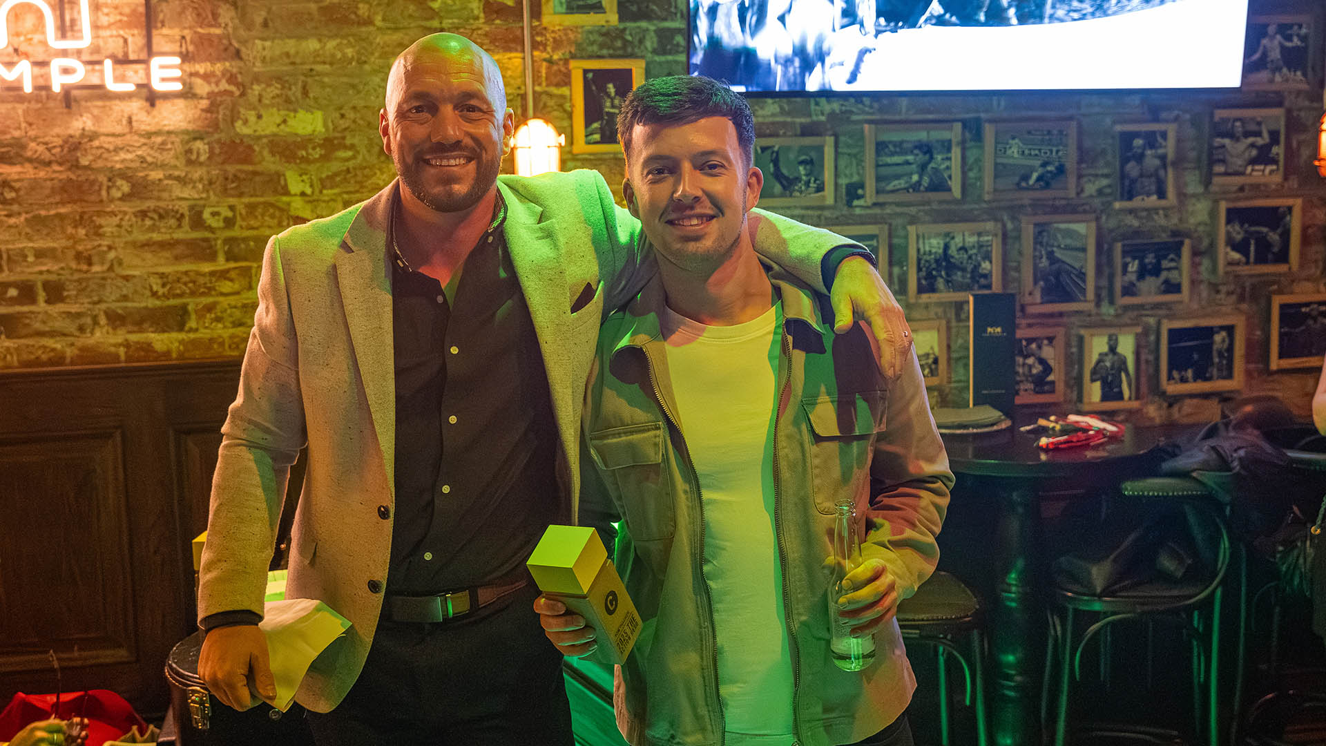 Simon presenting Tom with an award