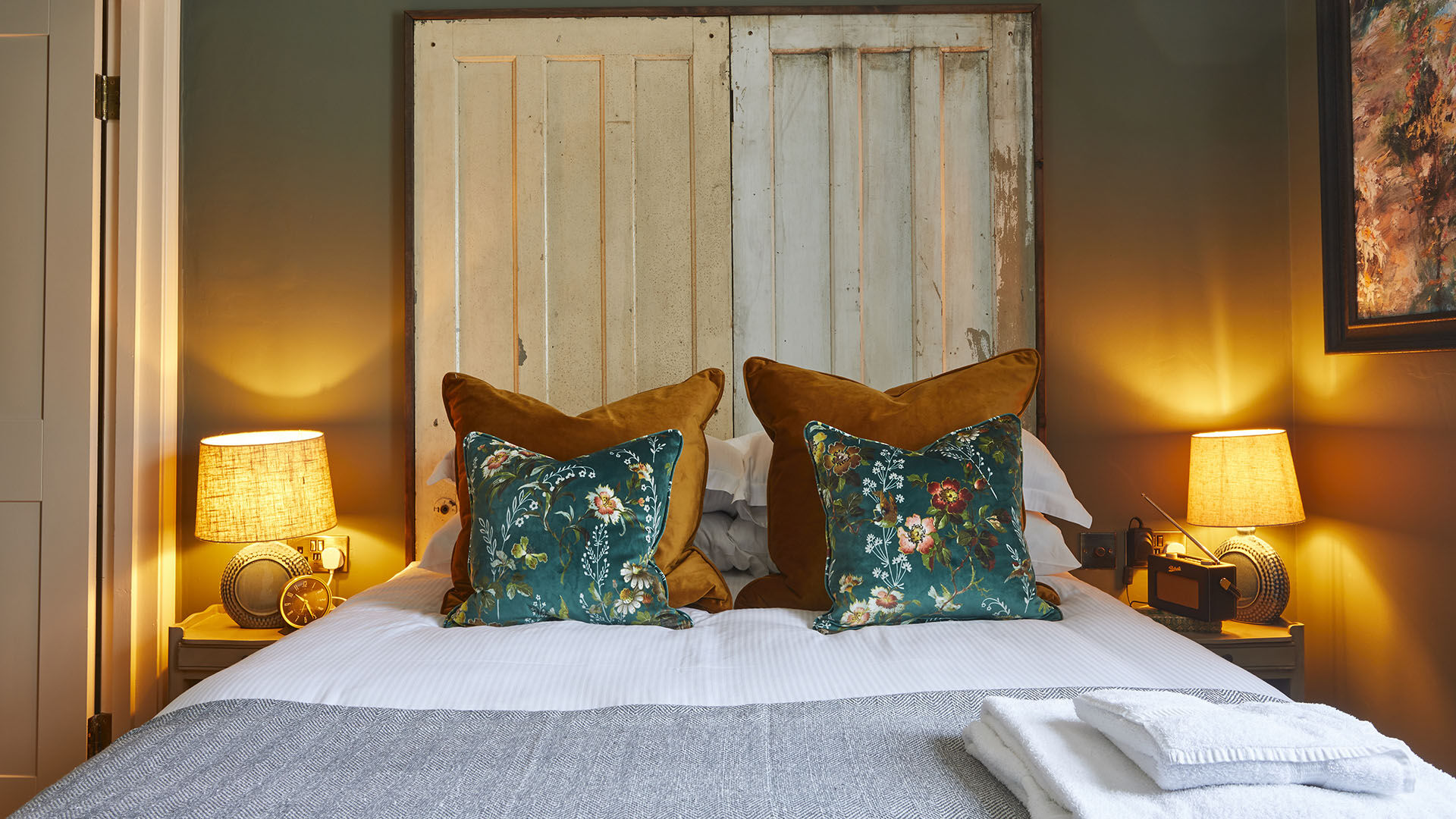 Bedroom with green wall and artwork