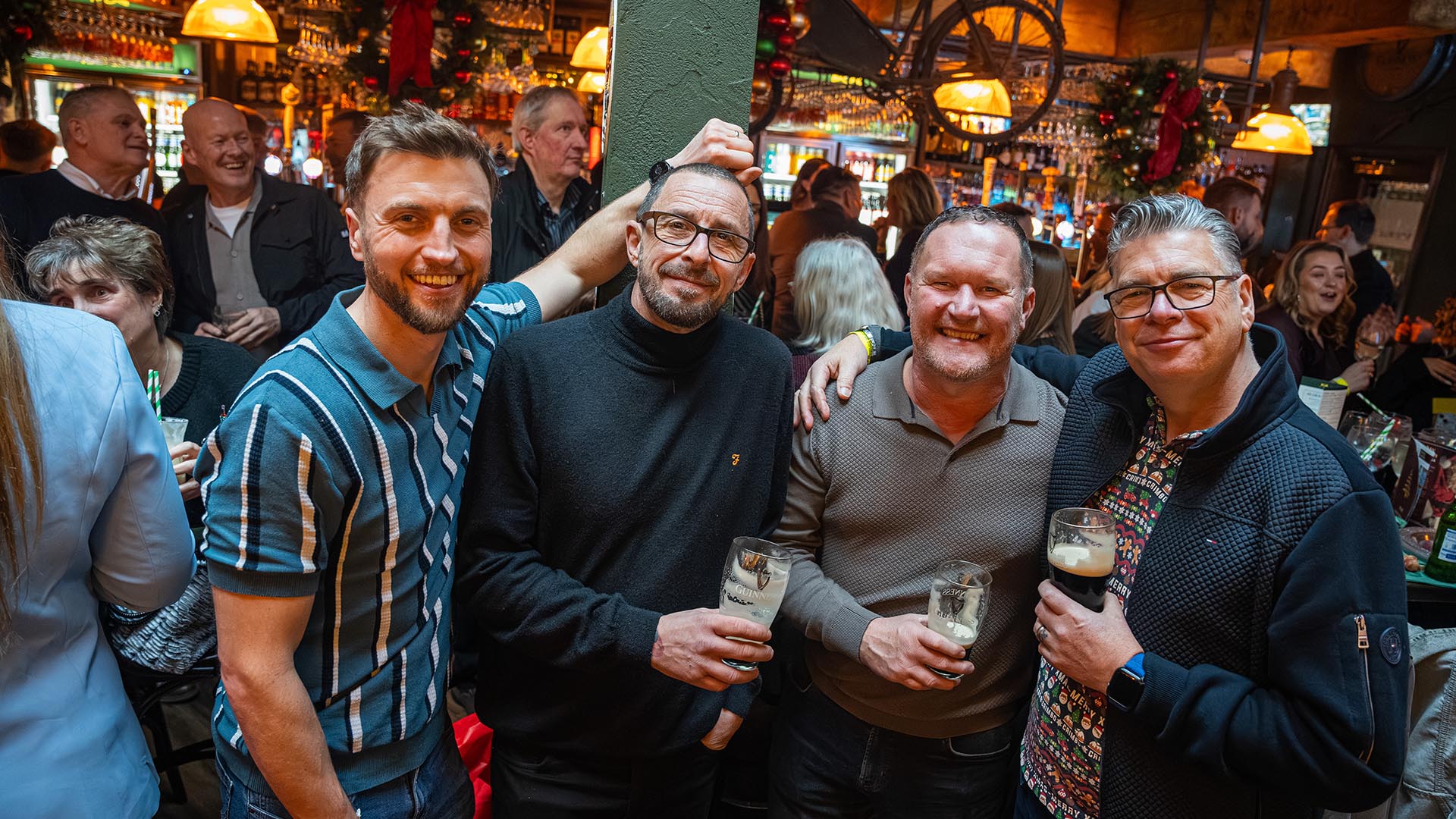 Team smiling with a pint