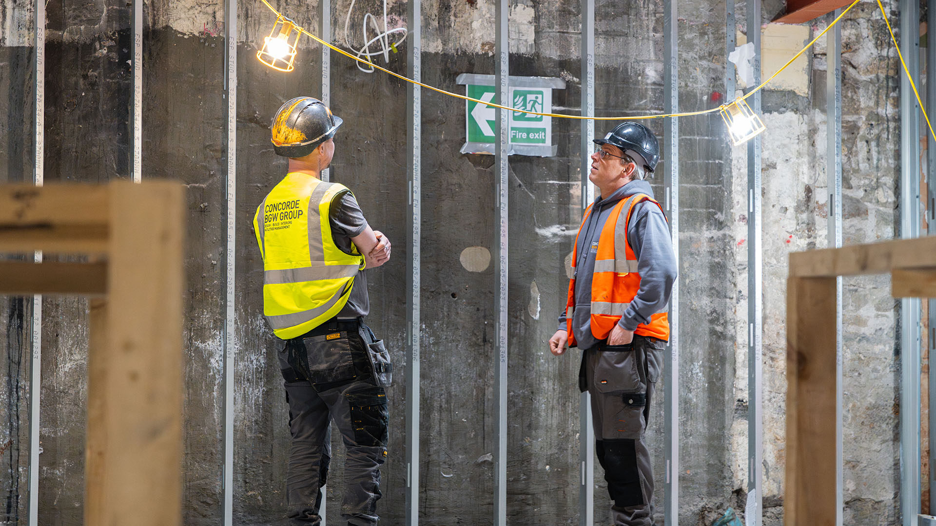 Progress on site, two men in hi vis on site