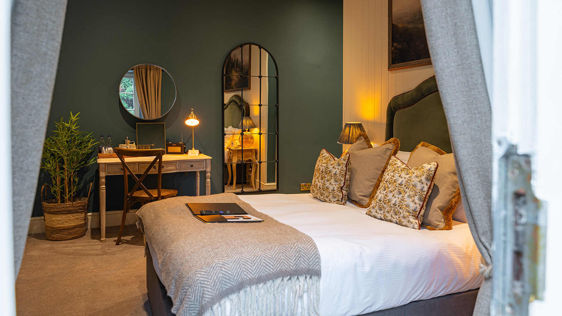 Bedroom with green wall and artwork