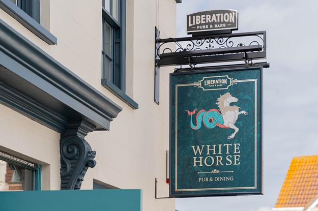 White horse jersey exterior of building with signage 