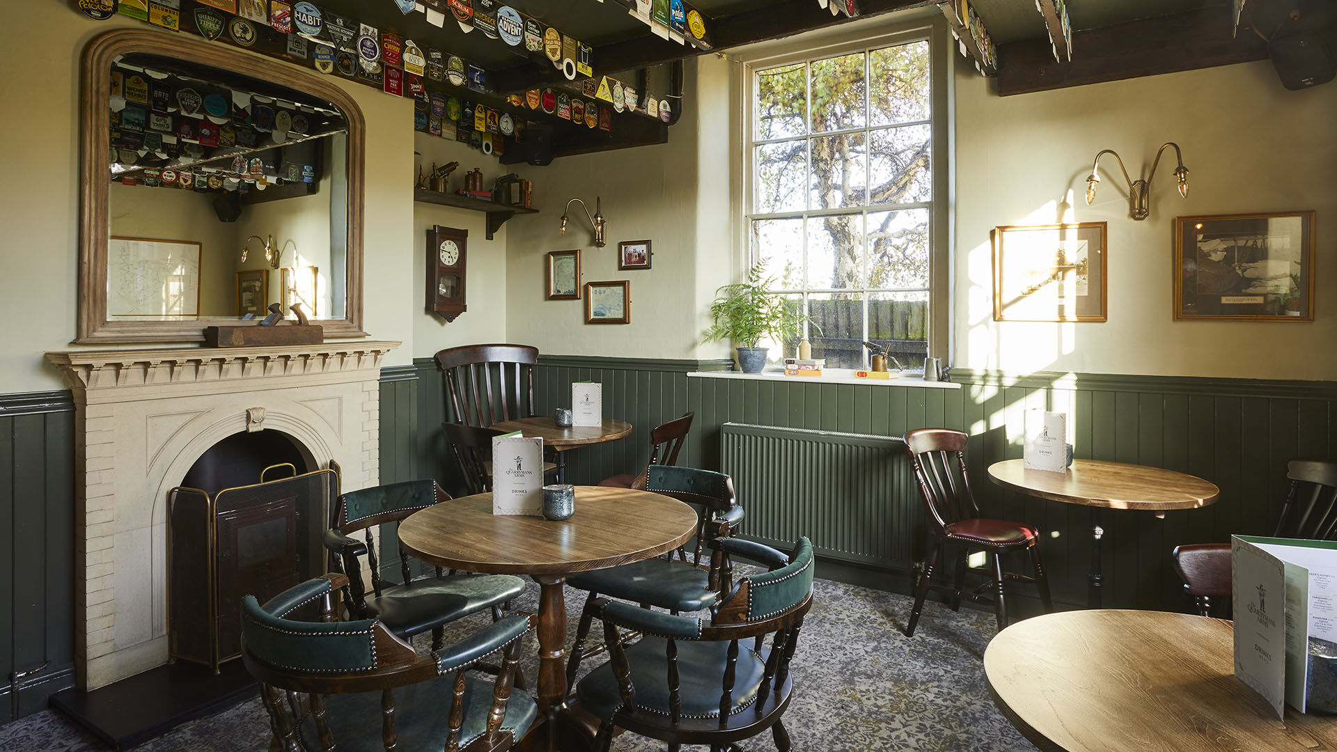 Blue pub in the centre of Axbridge with umbrellas outside 