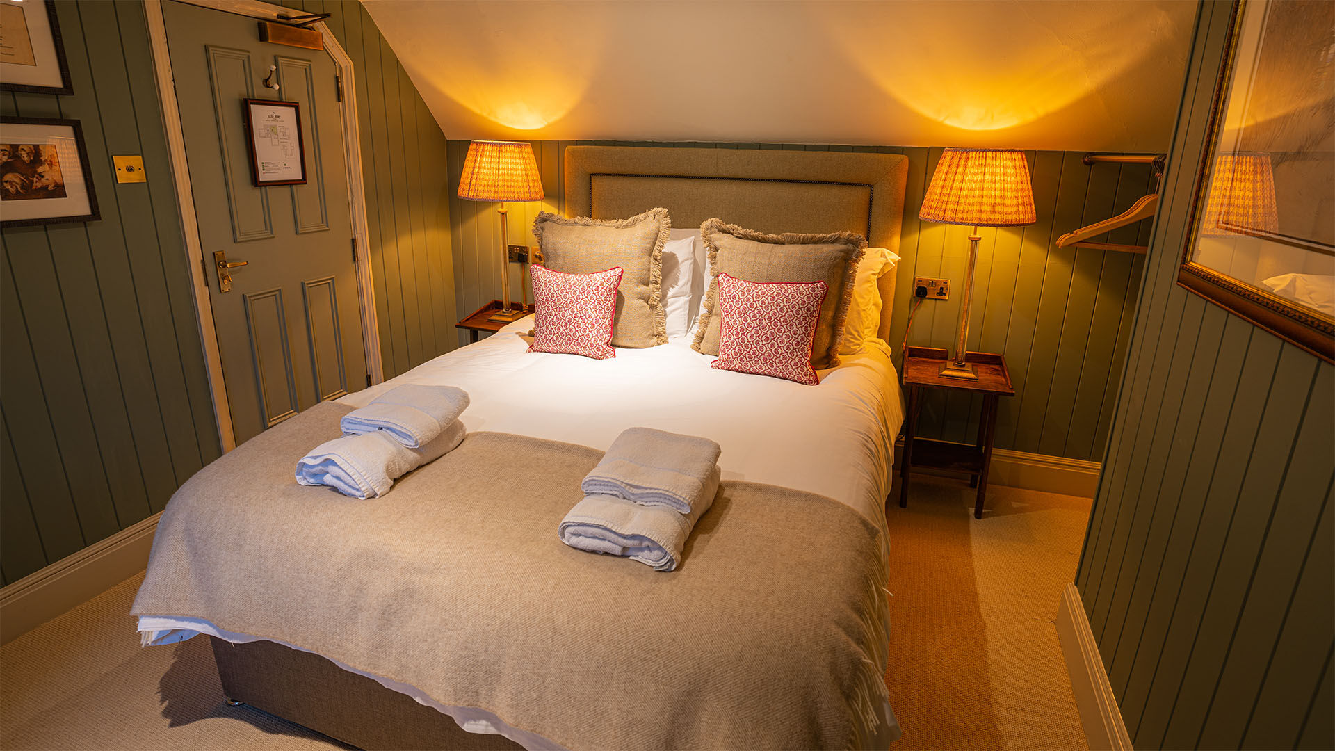 Bedroom with green wall and artwork