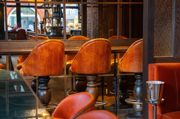 Barley Mow bar seating area with orange chairs