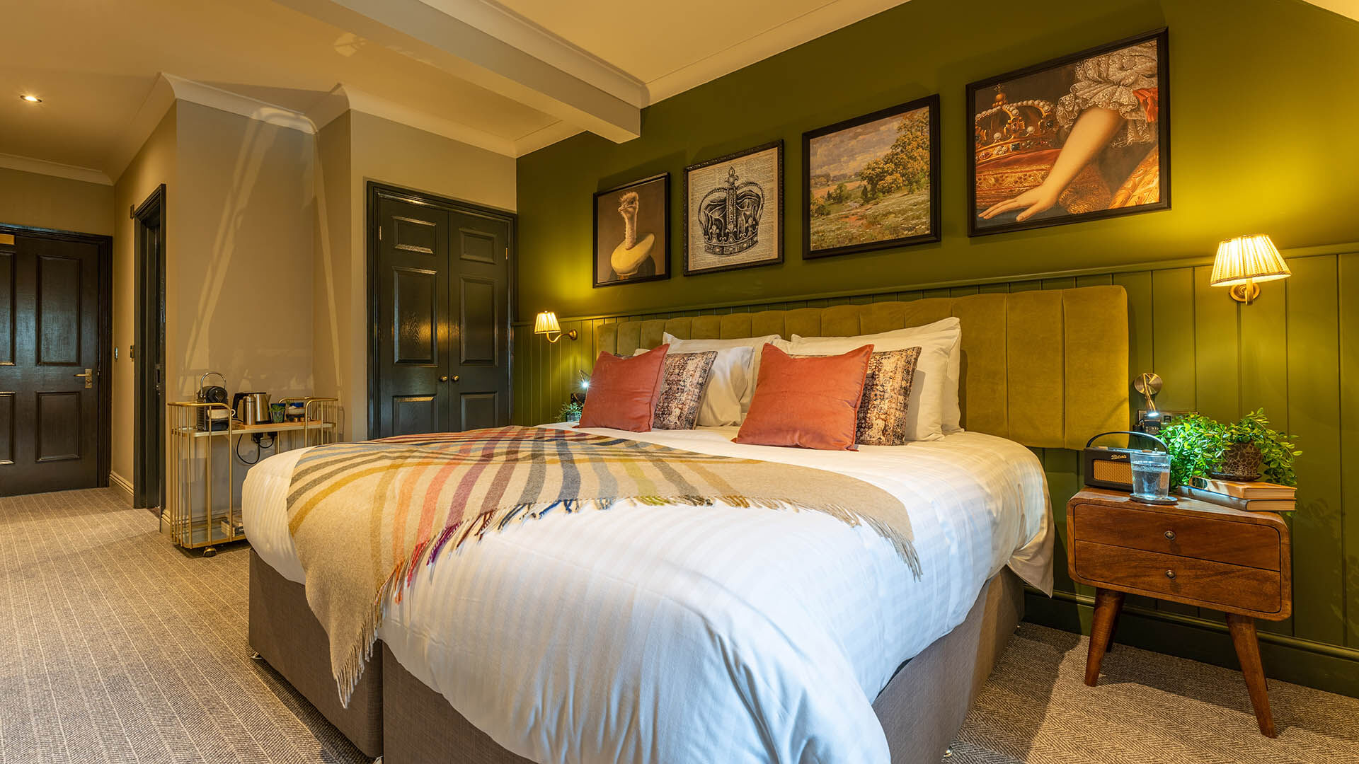 Bedroom with green wall and artwork