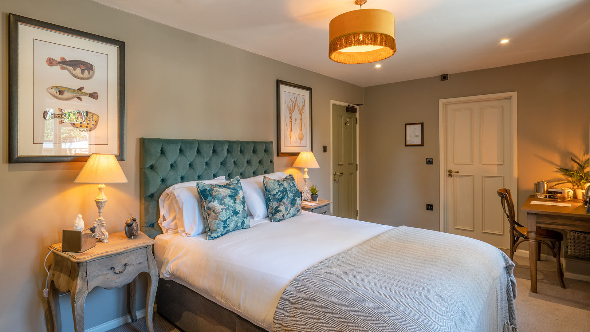 Bedroom with green wall and artwork