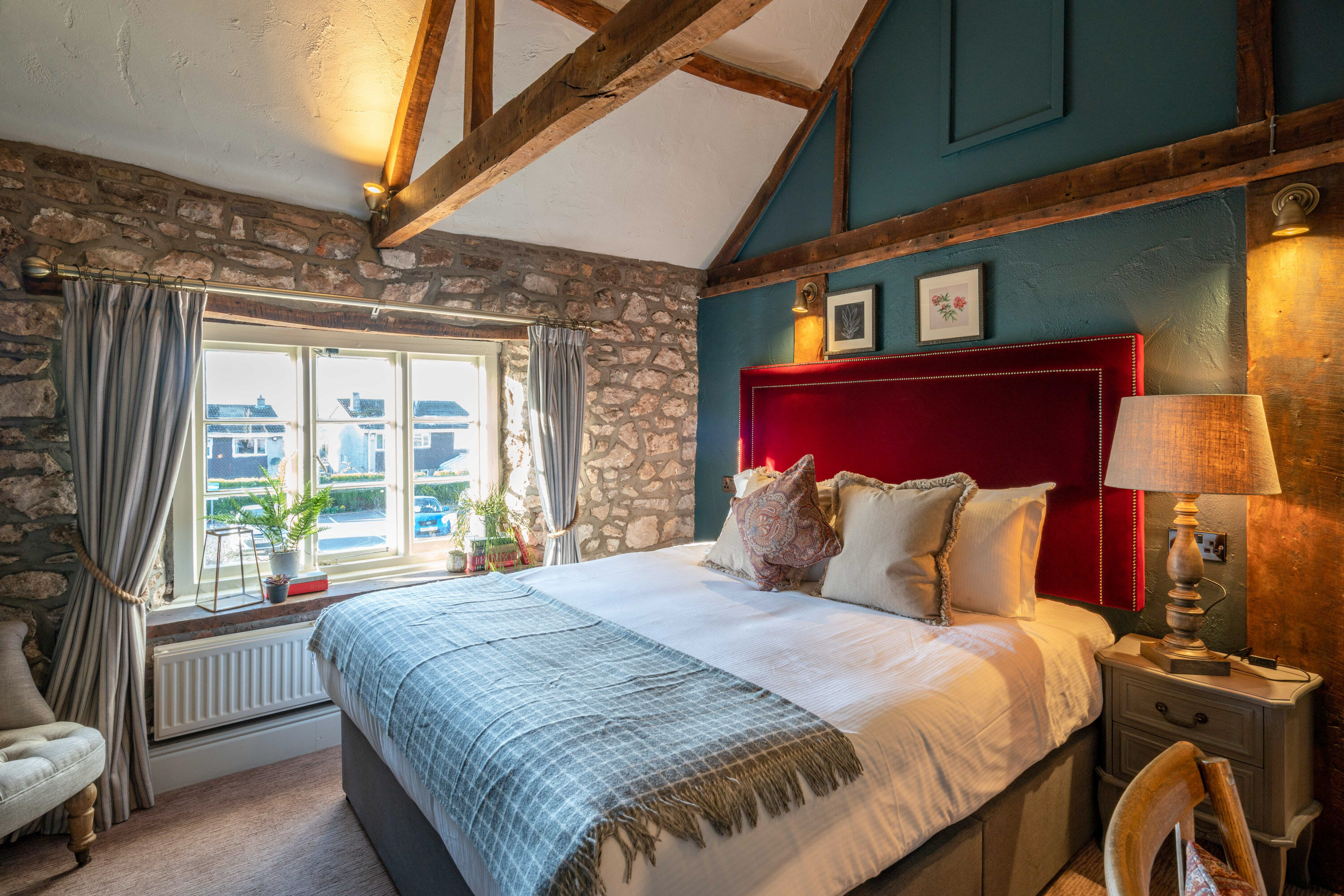 Bedroom with green wall and artwork
