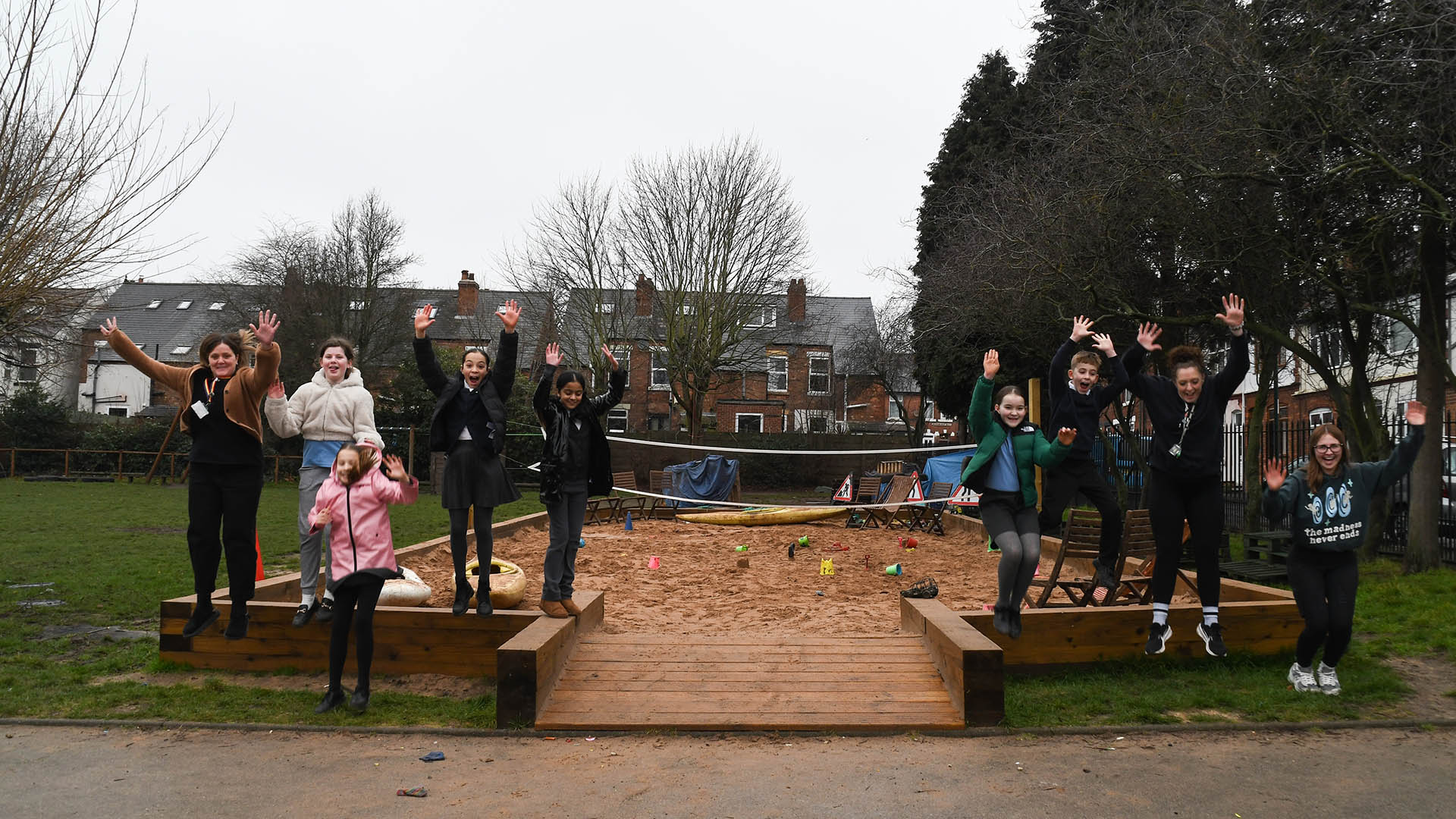 Haydn School sandpit kids and staff jumping
