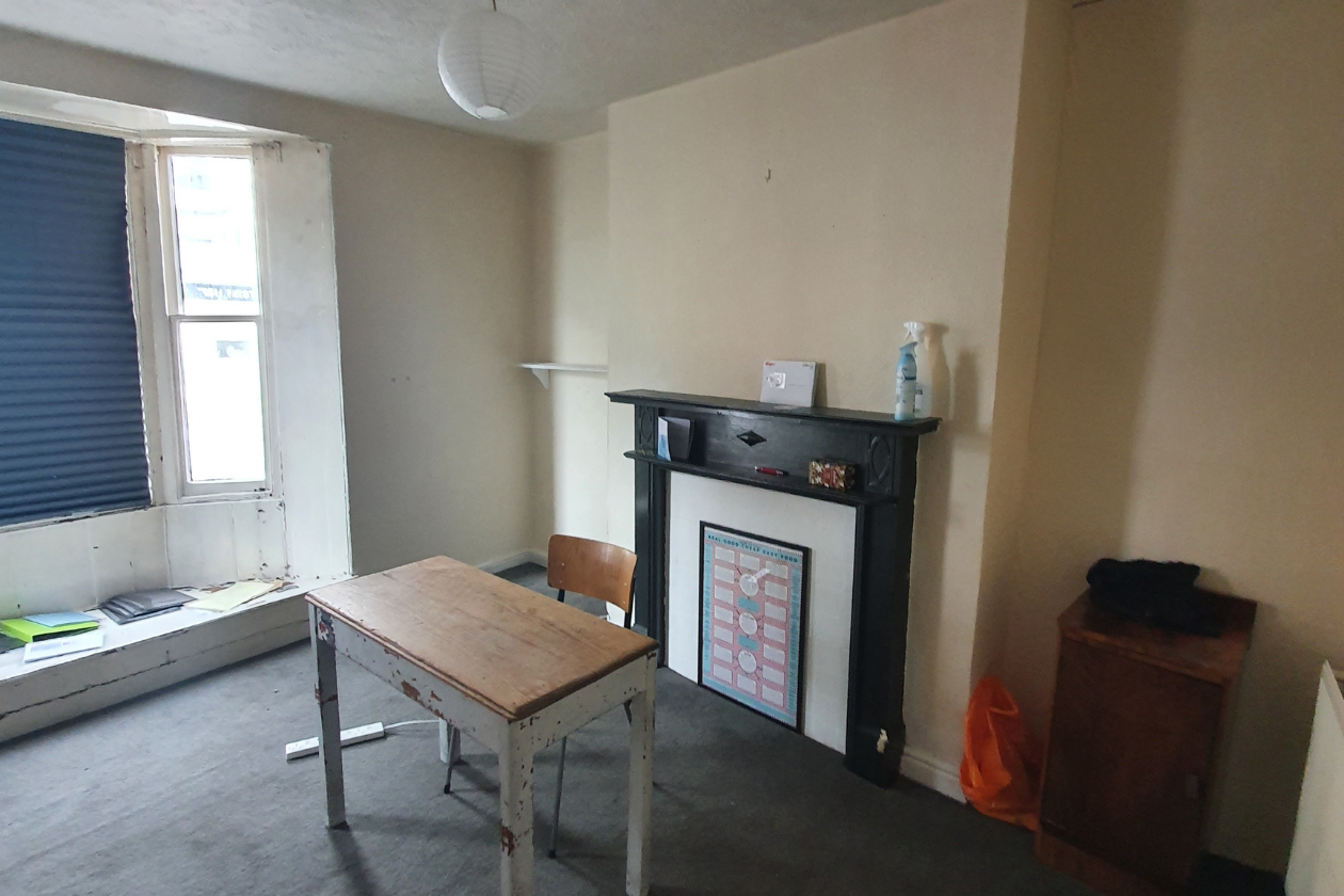 Room with a fireplace and windows