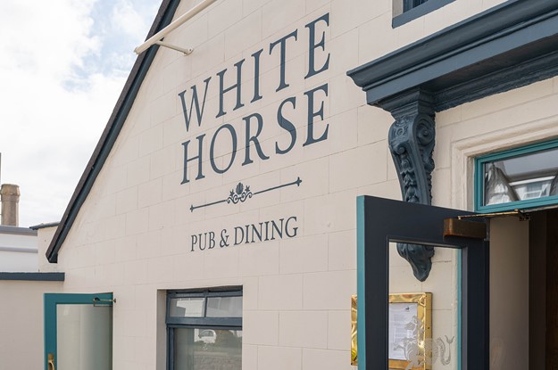 White horse jersey exterior of building signage 
